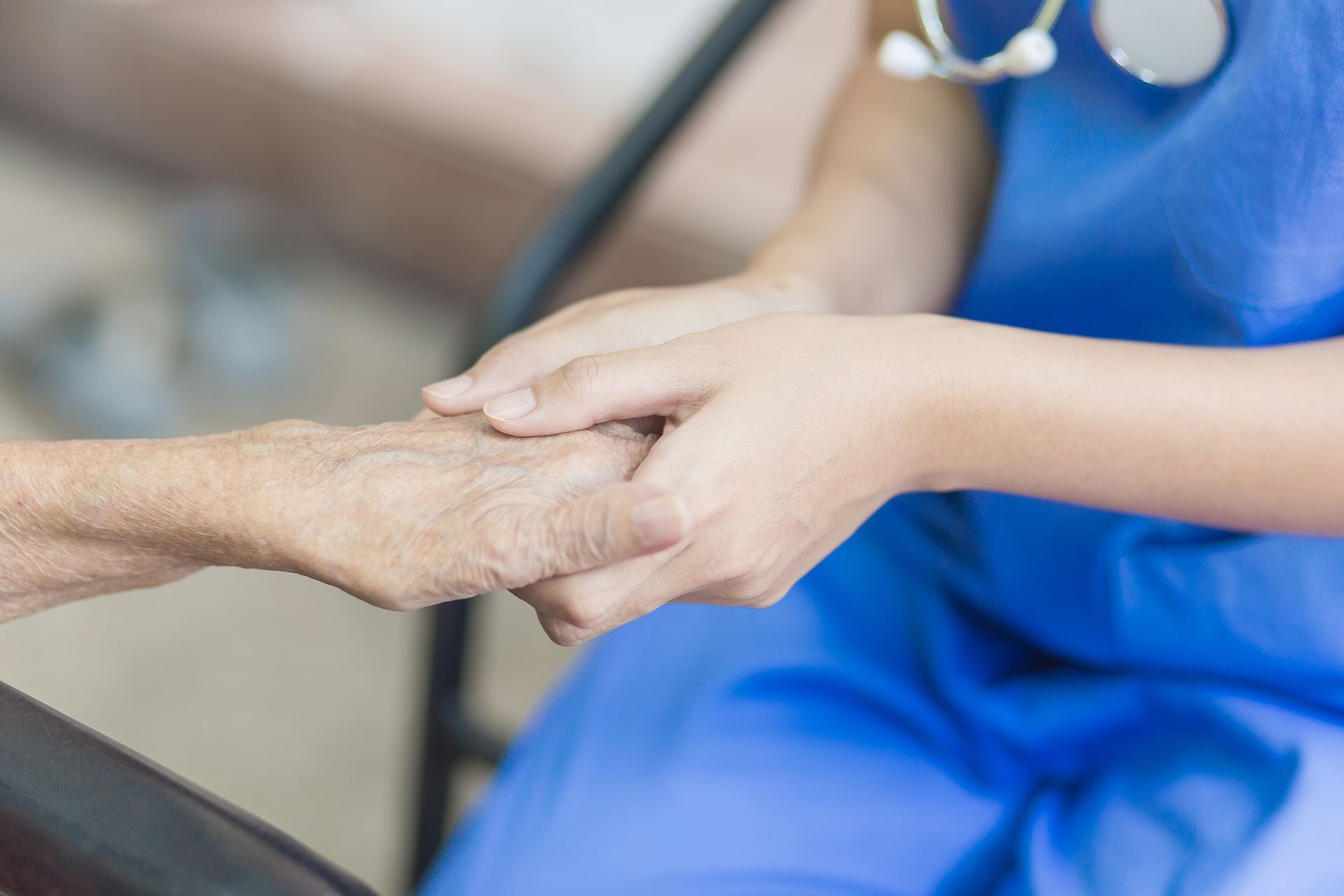 Hand of  eldery  woman with her caregiver at home. Home care or Elderly care concept.